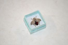 A sterling silver, marcasite and garnet brooch in