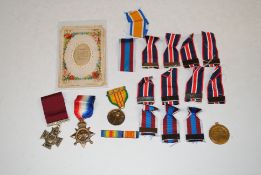 A bag containing mixed medal ribbons, badges etc