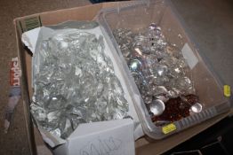 A box containing various chandelier prisms and oth