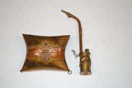 A brass and copper purse in the form of a cushion