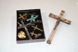 A box containing various crucifixes; pendants; a y
