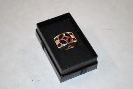 A large Brutalist sterling silver garnet set ring, size N/O, approx. 16gm
