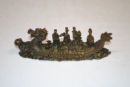 A Chinese bronzed ornament in the form of a dragon