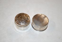 Two circular silver boxes