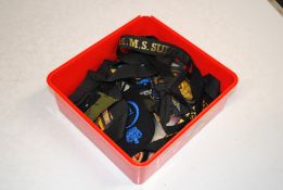 A box of assorted military cloth badges