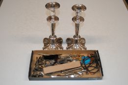A pair of silver plated candle sticks and a box co