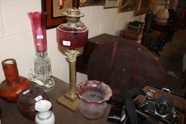 A Victorian Corinthian columned oil lamp with red