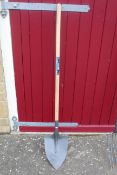 Long handled digging shovel. V