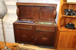 An oak court cupboard fitted two short drawers
