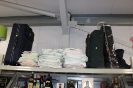 Three bundles of various linen and three travel ba