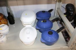A set of three blue graduated Le Creuset saucepans