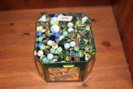 An advertising tin containing various marbles