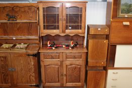 An oak dresser raised on cupboard base fitted two drawers