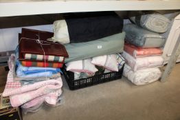 A collection of various quilts, fabric, pillows et