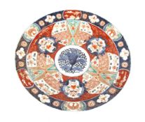A 19th Century Japanese Imari charger, decorated in the traditional palette, with flowers, figures