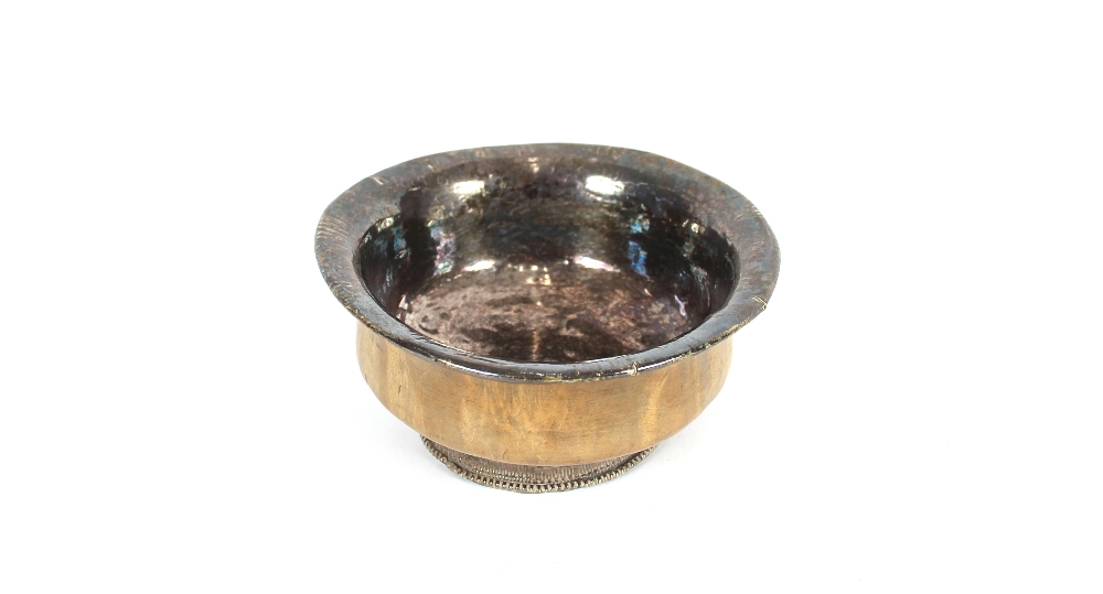 An antique wooden and white metal mounted bowl, of baluster form, the circular foot having raised