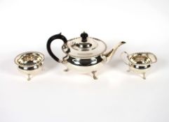 An Edwardian silver bachelors tea set, having gadrooned border decoration raised on pad feet, the