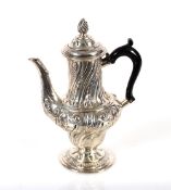 A Victorian silver baluster chocolate pot, with embossed foliate decoration, the domed hinged lid