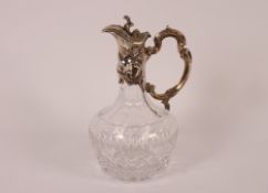 A cut glass claret jug of baluster form, with hobnail and thumb press decoration with plated foliate