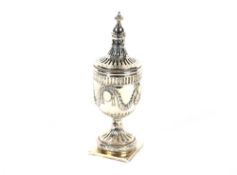 An Edwardian silver sugar shaker of baluster urn form, having raised mask and garland decoration and