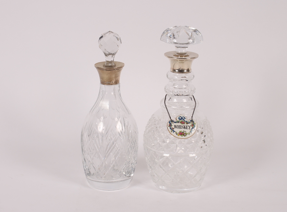A cut glass triple ring neck decanter, having silver collar and mushroom stopper, 29cm high and