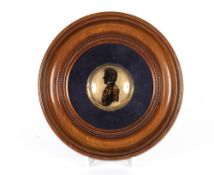 A circular 19th Century silhouette, head and shoulders portrait of an army officer, in circular