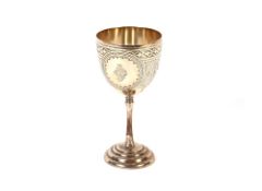 A Victorian silver pedestal goblet by George Unite, having foliate engraved decoration around a