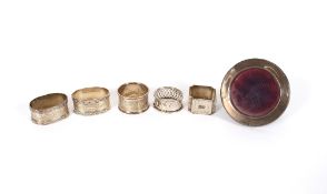 A pair of good quality silver engine turned decorated serviette rings, three others 141.7gms and a