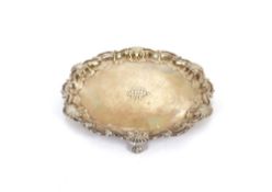 A late Victorian silver card tray, by The Goldsmiths and Silversmiths Company, having pie crust