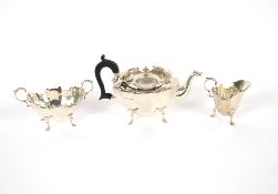 A late Victorian silver bachelors tea set of panelled form, having black wood handle raised on pad
