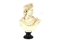 A white glazed classical bust of Apollo, raised on black socle base, 56cm high