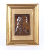 A bronze plaque, depicting a young girl with ribbon in her hair, inscribed 'Betty Mortimer' dated