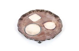 A silver presentation salver, having pie crust border raised on four scroll feet, Sheffield 1922,