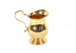 A small silver gilt baluster cream jug, 10cm high, Sheffield 1959, 140.7gms