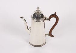 A late Victorian silver chocolate pot, of panelled tapering form, the domed lid surmounted by an