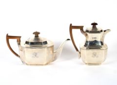 A silver tea pot, of octagonal form, having stylised border decoration, wooden handle and lift,