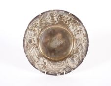 An Edwardian circular silver foliate embossed stand, London 1905; 24cm dia., 348gms