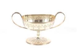 A Victorian silver pedestal sugar basin, with reeded scroll handles, embossed floral and garland