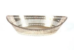 A George V oval silver bread basket, having gadrooned rim and pierced border decoration, Chester