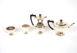 A George V four piece silver tea set, of octagonal panel form with stylised foliate band
