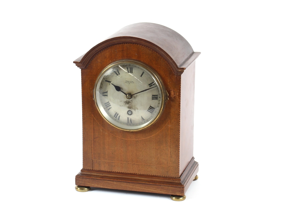 An Edwardian inlaid mahogany mantel timepiece, by Frederick Dixon, Oxford Street, the domed case