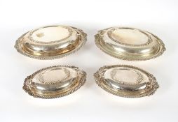 Two pairs of graduated plated entreé dishes, with shell and gadroon decorated borders and two