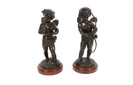 Capoy, a pair of bronze figures depicting cherubs one with bow the other with arrows on marble