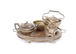 A miniature silver tea pot and tea kettle on stand, Birmingham 1908; a matching silver and oak two