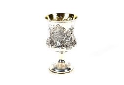 A Victorian silver baluster goblet, having raised foliate decoration and cartouche on out swept stem