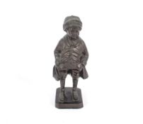 A bronze figure, of a young boy wearing britches, 19cm high