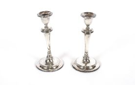 A pair of silver candlesticks, with reeded decoration, loaded bases, Sheffield 1908, 22cm high AF
