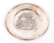 A 20th Century silver platter, decorated with a Dickensian scene, Birmingham 1972, 29cm dia. 789gms,