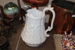A large Victorian relief moulded jug having white