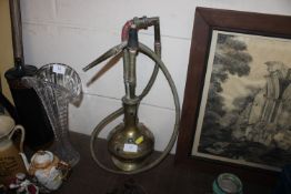 A brass hookah pipe with coloured stone decoration